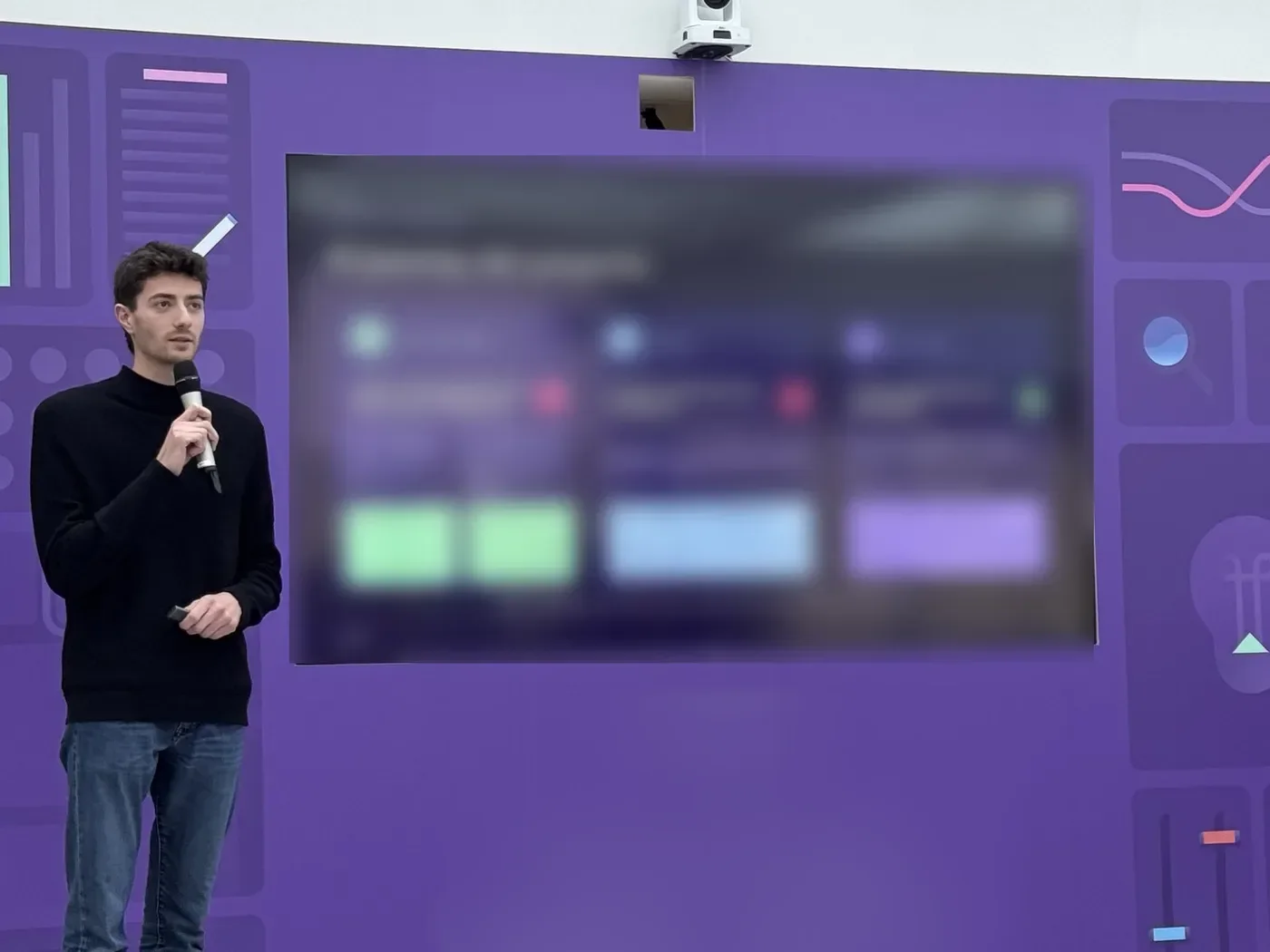 Mathieu presenting AQM on stage at a company all-hands